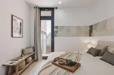a bedroom with a bed and a desk and a bed at Vietri - 2 bedrooms and terrace in Sant Antoni in Barcelona