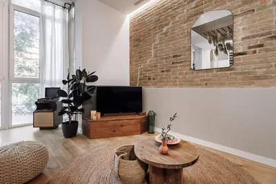 a bedroom with two beds and a brick wall at Aroche - 2 bedrooms in Sant Antoni in Barcelona