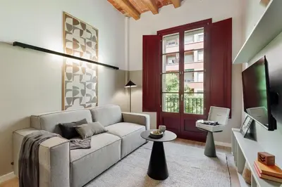 a living room with a table and chairs at Castell - 2 bedrooms and balcony in Sant Antoni in Barcelona