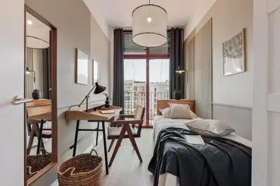 a bedroom with a large bed with a gray blanket at Vent - 2 bedrooms in Sant Antoni in Barcelona