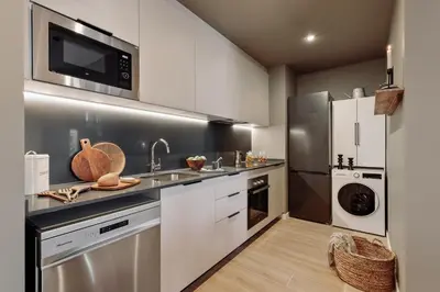 a kitchen with a table and chairs in a kitchen at Miravet - 2 bedrooms in Sant Antoni in Barcelona