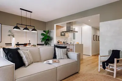 a bedroom with a large bed and a bathroom at Loja - 2 bedrooms in Sant Antoni in Barcelona