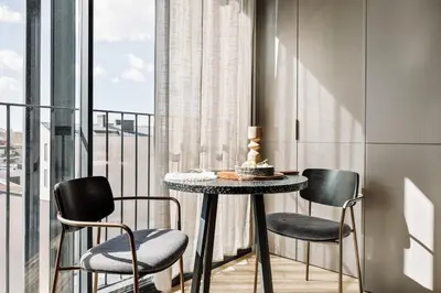 a bedroom with a large bed with a large window at Serrat - 1 bedroom and office in Poblenou in Barcelona