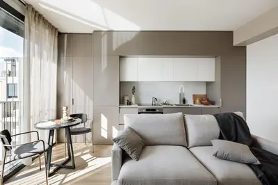 a table and two chairs in a room with a balcony at Serrat - 1 bedroom and office in Poblenou in Barcelona