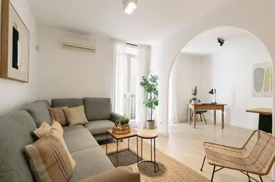 a living room with a couch and a table at Cathedral Ramblas Apartment in Barcelona