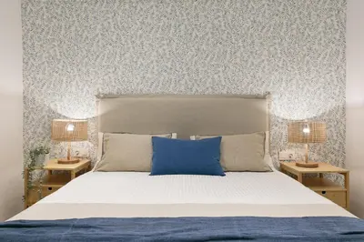 a bedroom with a bed with a blue pillow on it at Cathedral Ramblas Apartment in Barcelona