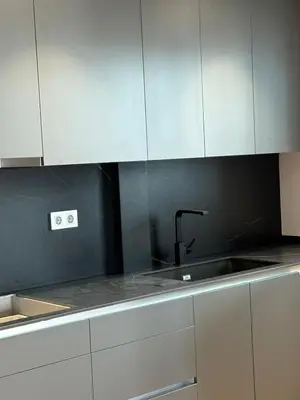 a kitchen with white cabinets and a sink at esplugues de llobregat in Barcelona