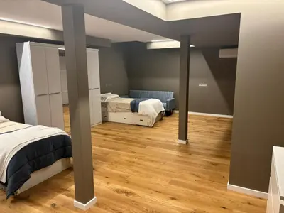 a bedroom with two beds and wooden floors at esplugues de llobregat in Barcelona