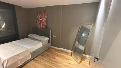 a small bedroom with a bed and a mirror at esplugues de llobregat in Barcelona