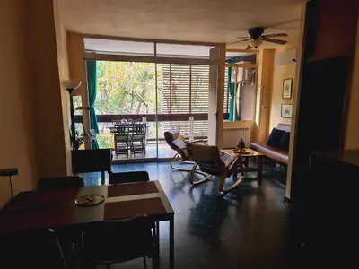 a living room filled with furniture and a large window at Josep Tarradellas 80 in Barcelona