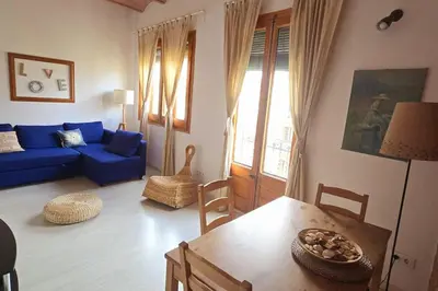 a living room with a blue couch and a table at Gracia Travesera 2 Bedrooms Renovated Apartment in Barcelona