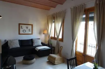 a living room with a couch and a chair at Gracia Travesera 2 Bedrooms Renovated Apartment in Barcelona