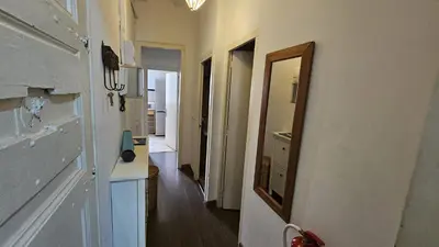 a hallway with a mirror on the wall and a hallway with a hallway at Romantic 19th century apartment in Barcelona