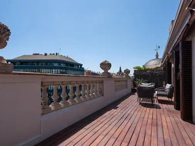 a balcony with a fence and a building in the background at Habitas Stay Barcelona in Barcelona