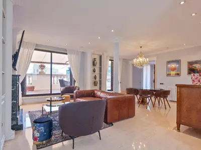 a living room with a leather couch and a table at Habitas Stay Barcelona in Barcelona