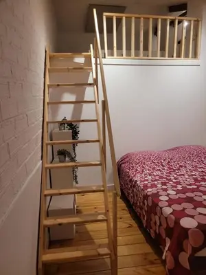 a bedroom with a ladder next to a bed at Cal 2 de Maig in Vilafranca del Penedès