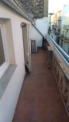 an alley with an open door on the side of a building at Cal 2 de Maig in Vilafranca del Penedès