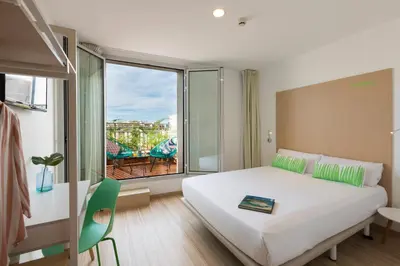 a bedroom with a large bed and a large window at SmartRoom Barcelona in Barcelona