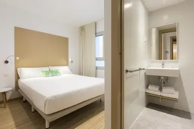 a hotel room with a bed and a sink at SmartRoom Barcelona in Barcelona