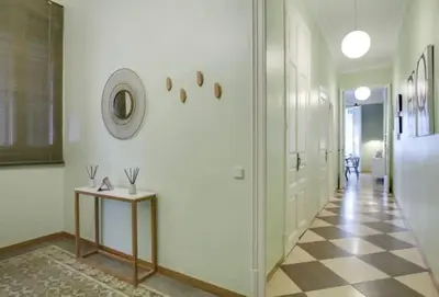 a hallway with white walls and a checkered floor at Passeig Sant Joan in Barcelona