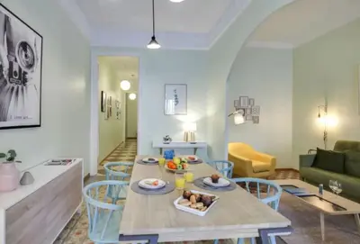a living room with a table and chairs at Passeig Sant Joan in Barcelona