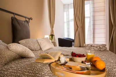 a tray of fruit and juice on a bed at Born Barcelona Hostel in Barcelona