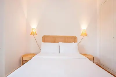 a bedroom with two lamps on top of a bed at Sweett - Nova Icaria Beach in Barcelona