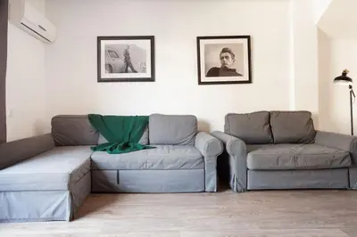 a living room with a couch and a chair at Canela Homes BARCELONA AUSIAS MARC in Barcelona