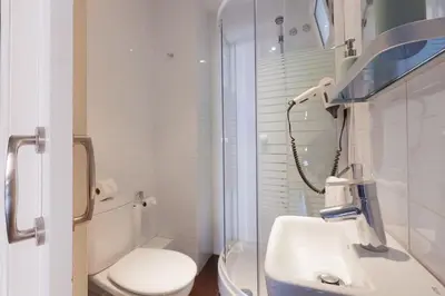 a white bathroom with a toilet and a sink at Canela Homes BARCELONA AUSIAS MARC in Barcelona