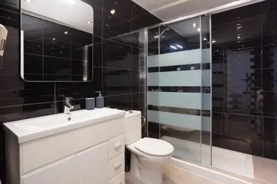 a bathroom with a toilet and a sink and a shower at Canela Homes BARCELONA AUSIAS MARC in Barcelona