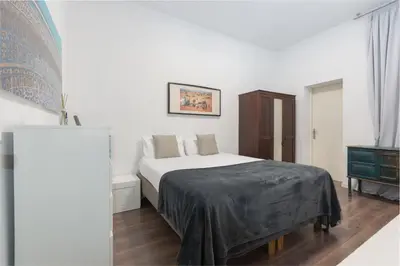 a white bedroom with a bed and a dresser at Canela Homes BARCELONA VALÈNCIA in Barcelona