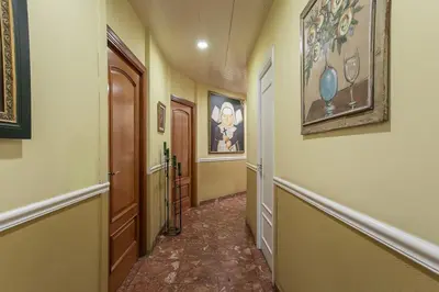 a hallway with two doors and paintings on the walls at Canela Homes BARCELONA CLASSIC in Barcelona