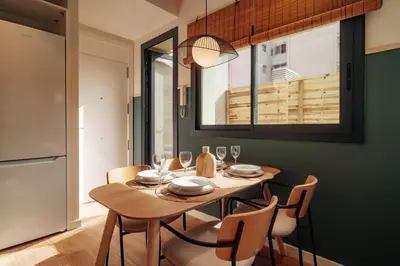 a dining room with a wooden table and chairs at Casa Morera in Barcelona