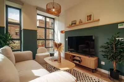 a living room with a couch and a tv at Casa Morera in Barcelona