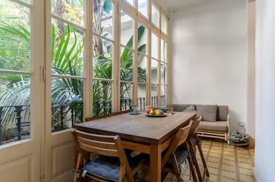 a dining room table with a bowl of fruit on it at Canela Homes BARCELONA PATIO in Barcelona