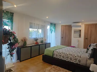 a bedroom with a bed and a window at INSPIRA MAISON Montaña y Mar in Teià