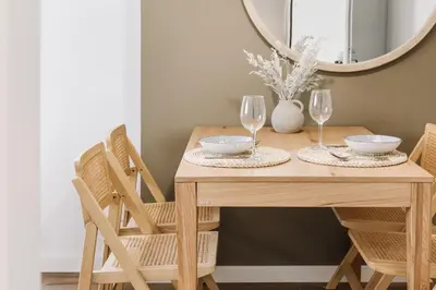 a dining room table with two glasses and a mirror at Casa Plaza in Barcelona