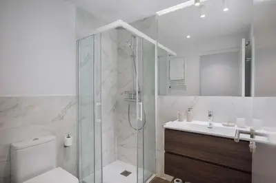 a bathroom with a shower and a toilet and a sink at Casa Plaza in Barcelona
