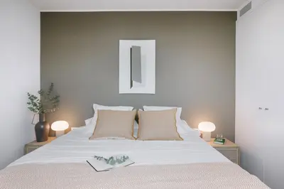 a bedroom with a large bed with white sheets and pillows at Casa Plaza in Barcelona