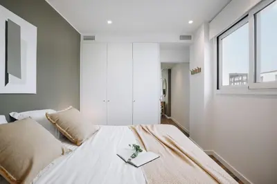 a bedroom with a bed with a book on it at Casa Plaza in Barcelona