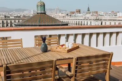 a wooden table with a basket of food on a balcony at Casa Plaza in Barcelona