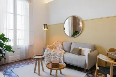 a living room with a couch and a mirror at Casa Ribera in Barcelona