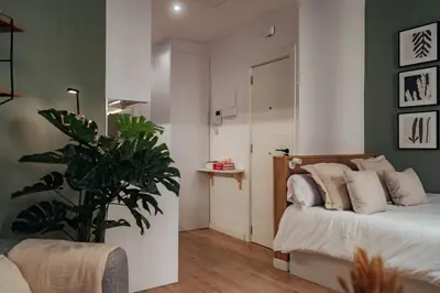 a bedroom with a bed and a plant in it at Casa Tapiz in Barcelona