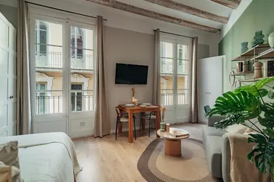 a living room with a couch and a table at Casa Tapiz in Barcelona