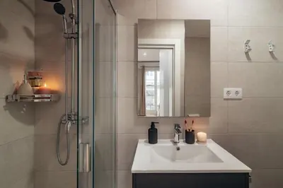 a bathroom with a sink and a shower at Casa Tapiz in Barcelona