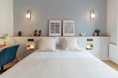 a bedroom with a bed with two pillows and a desk at Casa Atlas in Barcelona
