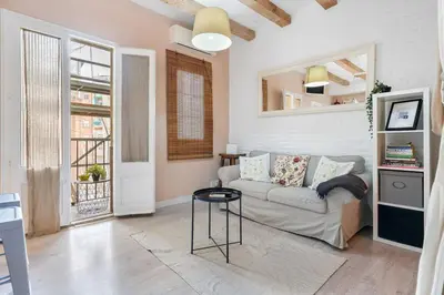 a living room with a couch and a table at Sunny Retro Flat Balcony in Poble Sec in Barcelona