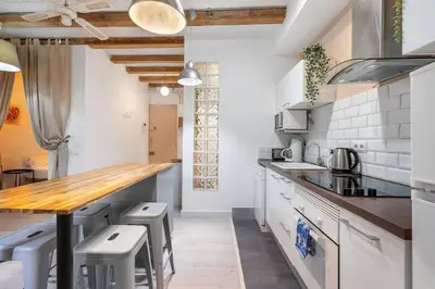 a kitchen with white appliances and a wooden counter top at Sunny Retro Flat Balcony in Poble Sec in Barcelona