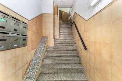 a staircase in a hallway in a building at Sunny Retro Flat Balcony in Poble Sec in Barcelona