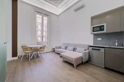 a living room with a couch and a table at Apartamento Rambla Cataluña 35 in Barcelona